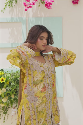 Video: Video of a model in a yellow floral tunic and champagne wide-leg trousers, showing the fabric's flow and the intricate lace craftsmanship.
