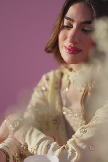 Video shows close‑up of Vivi ensemble dupatta, butter‑yellow pure seesha silk with intricate hand embroidery, sequined accents, and tassel finish.
