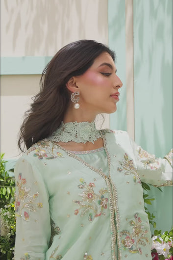 VIDEO: The model showcasing the fluid movement of the mint green silk trousers and the detailed craftsmanship of the embroidered tunic.
