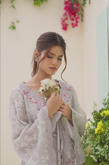 Video: Model showcasing the details, fabric movement, and embroidery of a pastel grey embroidered organza jacket suit.

