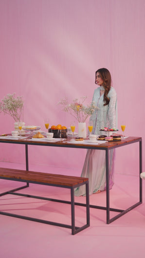 Camera pans across Sirha pastel blue Chantilly lace shirt with silver handwork, flowing charmeuse silk saree‑style pants, and asymmetrical two‑toned dupatta, highlighting drape and embroidery details.
