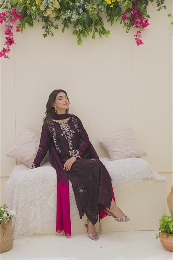 Video: A video of a model posing and moving in a deep purple embroidered tunic with a fuchsia ombre scarf to demonstrate the fabric's movement and detail.
