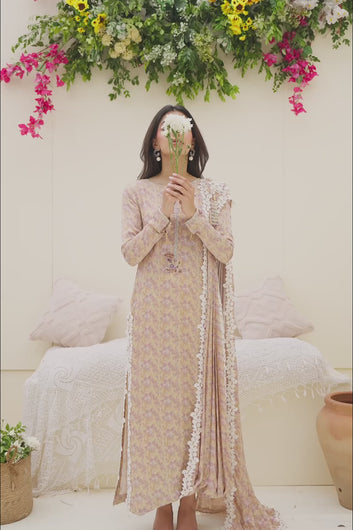A video featuring the model moving and posing in the golden floral print dress to demonstrate the fabric's movement and the drape of the lace-bordered dupatta.
