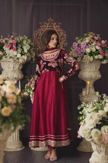 A cinematic video featuring a model in a deep plum and maroon flared pishwas, showcasing the movement of the voluminous skirt, the shimmer of the tilla-worked velvet bodice.
